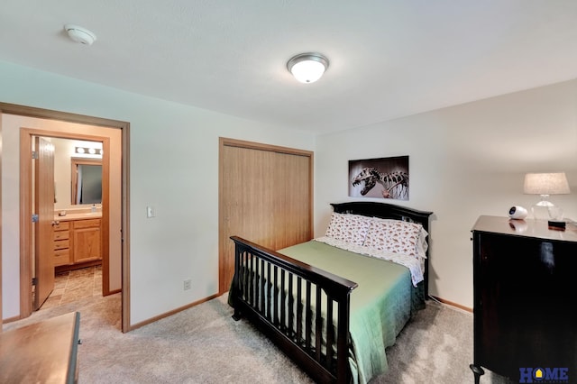 2222 SW Soukup Dr, Lincoln, NE 68522 - bedroom with light carpet, a closet, and baseboards