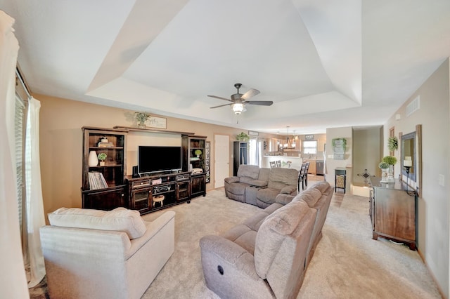 2222 SW Soukup Dr, Lincoln, NE 68522 - living area featuring a raised ceiling, ceiling fan, and light carpet