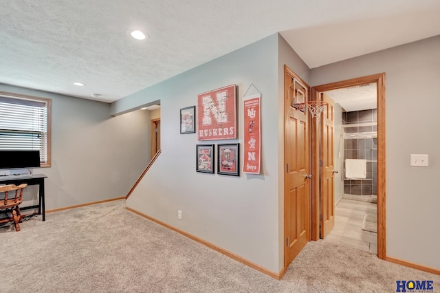 2222 SW Soukup Dr, Lincoln, NE 68522 - below grade area with carpet floors, baseboards, a textured ceiling, and recessed lighting