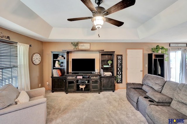 2222 SW Soukup Dr, Lincoln, NE 68522 - living room with a tray ceiling, carpet flooring, and a ceiling fan
