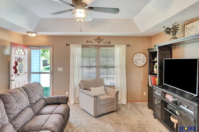 2222 SW Soukup Dr, Lincoln, NE 68522 - living area with a raised ceiling, a ceiling fan, light colored carpet, lofted ceiling, and baseboards