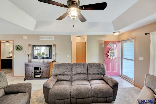 2222 SW Soukup Dr, Lincoln, NE 68522 - living room with ceiling fan, light colored carpet, and a tray ceiling
