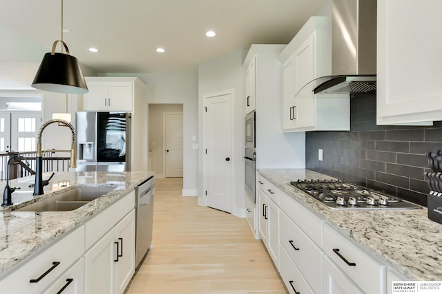 18108 Locust St, Elkhorn, NE 68022 - kitchen with wall chimney range hood, a sink, appliances with stainless steel finishes, decorative backsplash, and light wood finished floors