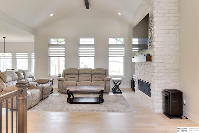 18108 Locust St, Elkhorn, NE 68022 - living area featuring beam ceiling, a fireplace, light wood finished floors, healthy amount of natural light, and high vaulted ceiling