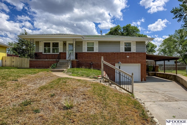view of front of home with driveway, brick siding, fence, an attached garage, and covered porch