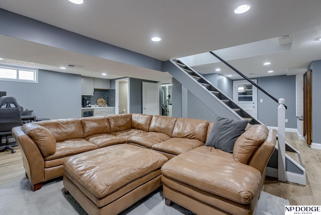 living area featuring stairs, recessed lighting, light wood-style flooring, and baseboards