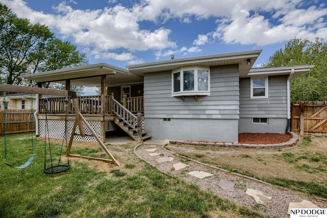 rear view of house with crawl space and stairs