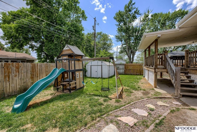 view of yard featuring a playground, a storage unit, and an outdoor structure