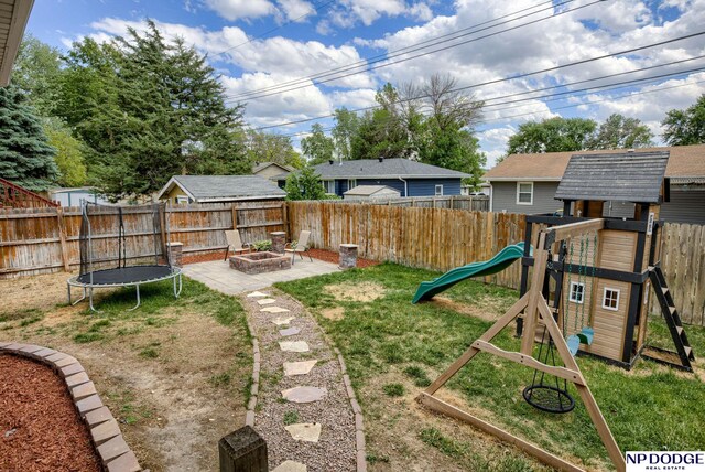 view of yard with a playground and a fire pit