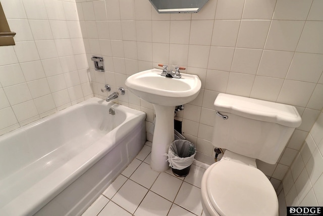 1807 N Platte Ave, Fremont, NE 68025 - full bath with tile patterned floors, toilet, a bath, tile walls, and a sink