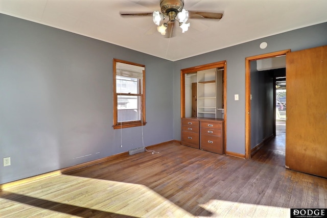 1807 N Platte Ave, Fremont, NE 68025 - unfurnished bedroom with wood finished floors, baseboards, and ceiling fan
