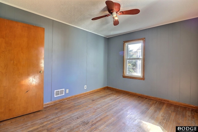 1807 N Platte Ave, Fremont, NE 68025 - empty room with hardwood / wood-style floors, ceiling fan, baseboards, a textured ceiling, and ornamental molding