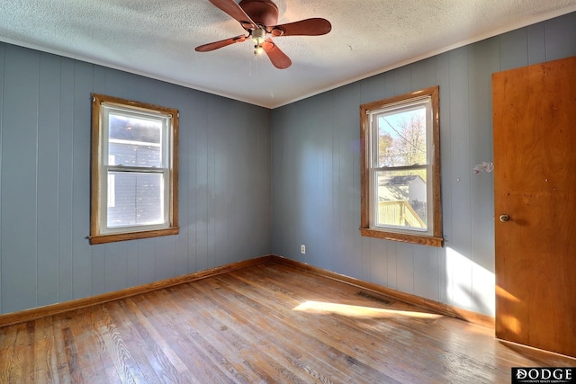 1807 N Platte Ave, Fremont, NE 68025 - spare room with hardwood / wood-style flooring, a textured ceiling, baseboards, and ceiling fan
