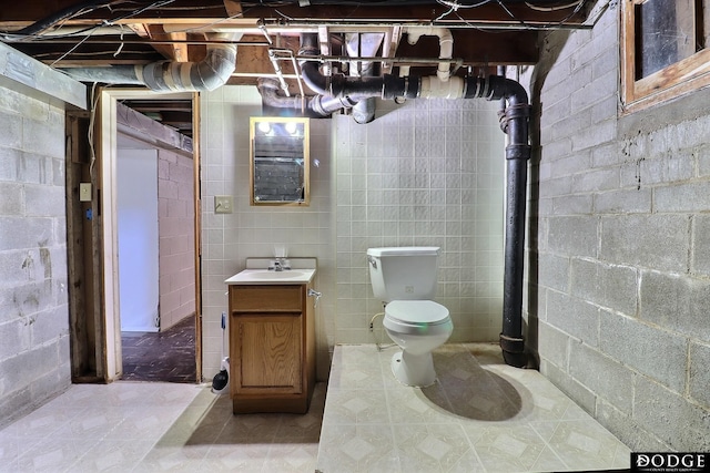 1807 N Platte Ave, Fremont, NE 68025 - bathroom featuring toilet, vanity, and concrete block wall