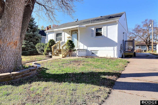 1807 N Platte Ave, Fremont, NE 68025 - bungalow with brick siding, a front lawn, a shingled roof, and a chimney