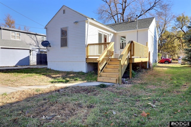 1807 N Platte Ave, Fremont, NE 68025 - view of front of property with a deck, stairs, a front lawn, and roof with shingles
