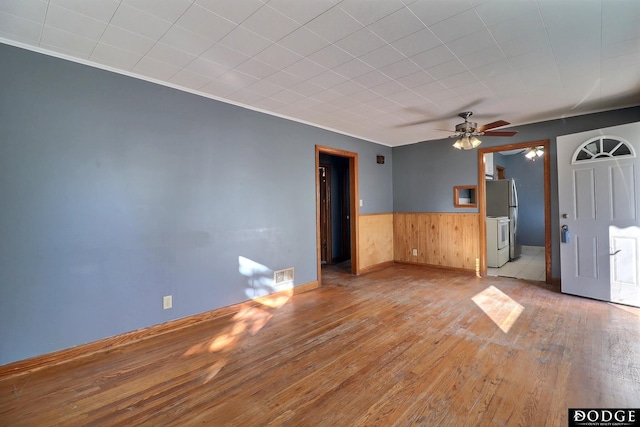 1807 N Platte Ave, Fremont, NE 68025 - unfurnished room featuring hardwood / wood-style flooring, a wainscoted wall, a ceiling fan, wooden walls, and baseboards