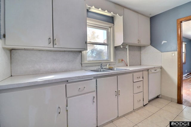 1807 N Platte Ave, Fremont, NE 68025 - kitchen featuring dishwasher, a sink, light countertops, tasteful backsplash, and light tile patterned floors