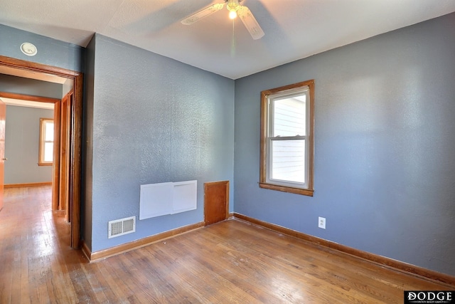 1807 N Platte Ave, Fremont, NE 68025 - empty room featuring hardwood / wood-style floors, ceiling fan, a textured wall, baseboards, and a smoke detector