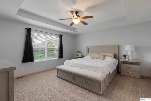 18652 Van Camp Dr, Omaha, NE 68130 - bedroom with a tray ceiling, light colored carpet, baseboards, and ceiling fan