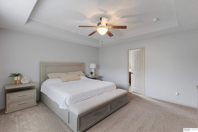 18652 Van Camp Dr, Omaha, NE 68130 - bedroom with a tray ceiling, light colored carpet, and ceiling fan