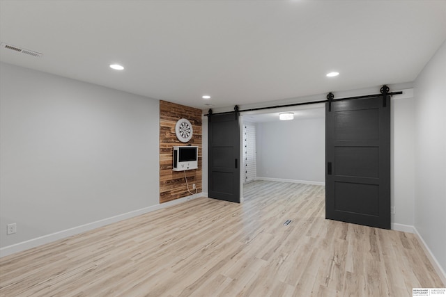 18652 Van Camp Dr, Omaha, NE 68130 - spare room featuring a barn door, baseboards, recessed lighting, and light wood finished floors