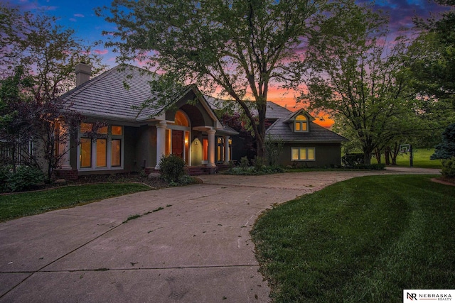 1125 Stone Creek Dr, Blair, NE 68008 - view of front of home featuring a chimney, a front yard, driveway, and a tile roof