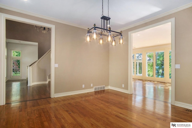1125 Stone Creek Dr, Blair, NE 68008 - spare room featuring a chandelier, wood finished floors, baseboards, ornamental molding, and stairway