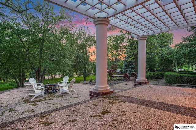 1125 Stone Creek Dr, Blair, NE 68008 - patio terrace at dusk with an outdoor fire pit and a pergola