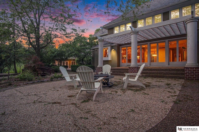 1125 Stone Creek Dr, Blair, NE 68008 - back of house at dusk featuring an outdoor fire pit