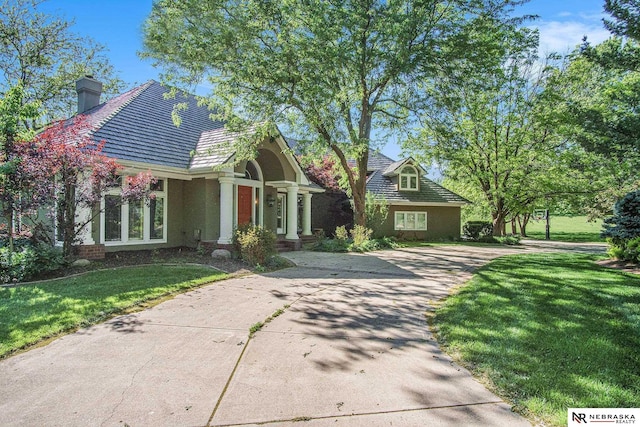 1125 Stone Creek Dr, Blair, NE 68008 - view of front facade with driveway, a front lawn, and a chimney