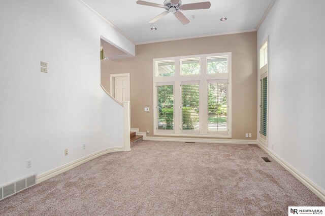 1125 Stone Creek Dr, Blair, NE 68008 - unfurnished living room featuring carpet floors, crown molding, ceiling fan, and baseboards