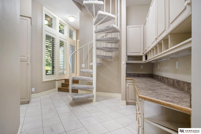 1125 Stone Creek Dr, Blair, NE 68008 - staircase featuring tile patterned floors and baseboards