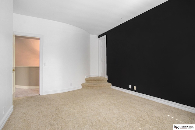 1125 Stone Creek Dr, Blair, NE 68008 - unfurnished room with carpet floors, baseboards, vaulted ceiling, and stairs