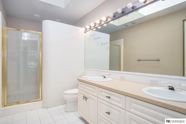 1125 Stone Creek Dr, Blair, NE 68008 - full bath with tile patterned floors, a stall shower, double vanity, toilet, and tile walls