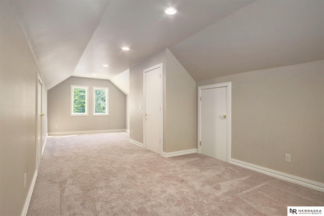 1125 Stone Creek Dr, Blair, NE 68008 - additional living space with lofted ceiling, light colored carpet, baseboards, and recessed lighting