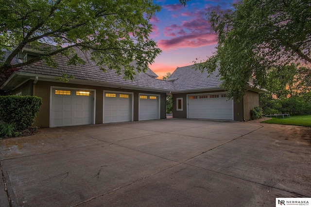 1125 Stone Creek Dr, Blair, NE 68008 - view of front of home with concrete driveway, stucco siding, a tiled roof, and a garage