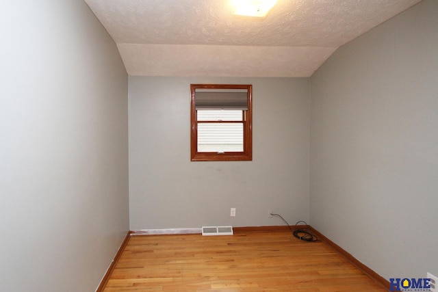 1701 N 73rd St, Lincoln, NE 68505 - spare room with vaulted ceiling, light wood-style flooring, and baseboards