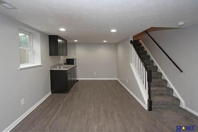 1701 N 73rd St, Lincoln, NE 68505 - bar featuring a sink, dark wood-style flooring, stairway, baseboards, and recessed lighting