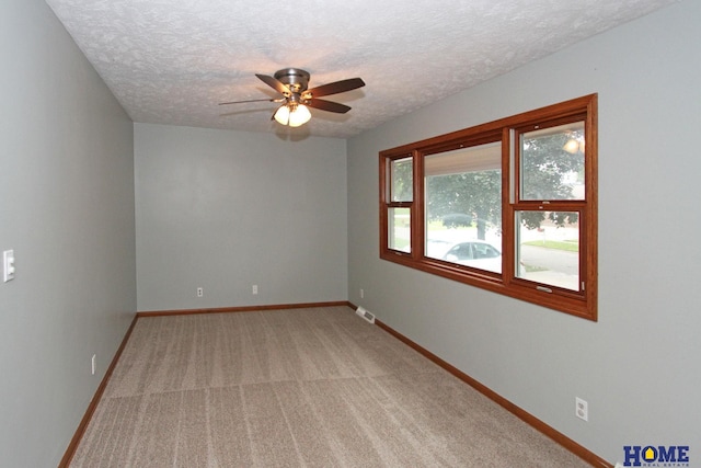 1701 N 73rd St, Lincoln, NE 68505 - spare room with ceiling fan, a textured ceiling, baseboards, and light colored carpet