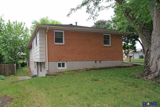 1701 N 73rd St, Lincoln, NE 68505 - view of property exterior featuring brick siding and central AC unit