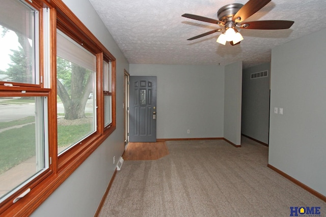 1701 N 73rd St, Lincoln, NE 68505 - carpeted empty room featuring a textured ceiling, baseboards, and a ceiling fan