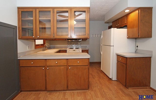 1701 N 73rd St, Lincoln, NE 68505 - kitchen featuring a sink, light wood-style floors, light countertops, and a textured ceiling