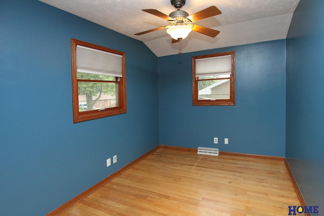 1701 N 73rd St, Lincoln, NE 68505 - spare room featuring baseboards, wood finished floors, vaulted ceiling, and a ceiling fan