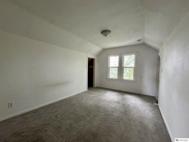 1300 Claremont St, Lincoln, NE 68508 - additional living space with lofted ceiling, carpet floors, and baseboards