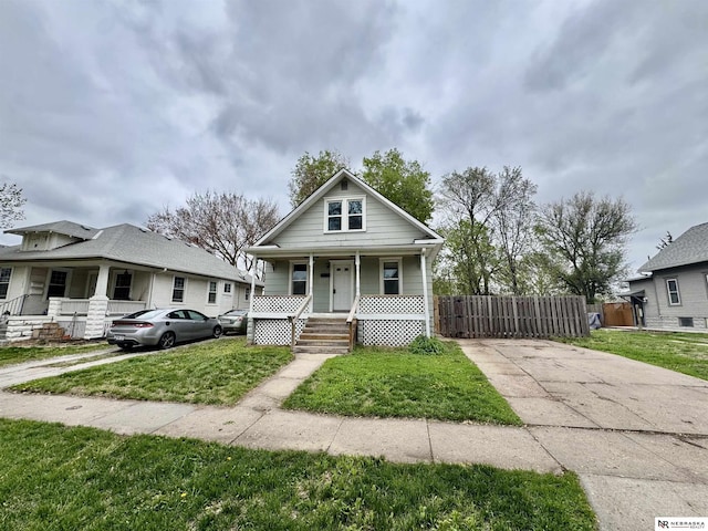 1300 Claremont St, Lincoln, NE 68508 - bungalow-style house featuring covered porch and driveway