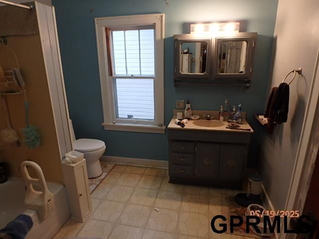 1935 S 11th St, Omaha, NE 68106 - bathroom with a tub, vanity, toilet, and baseboards