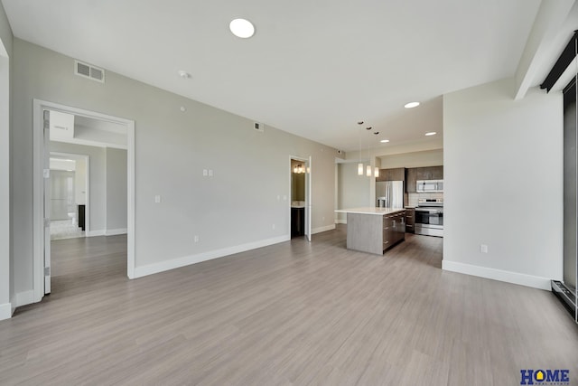 1125 Q St Unit 1401, Lincoln, NE 68508 - unfurnished living room featuring baseboards, recessed lighting, and light wood-style floors