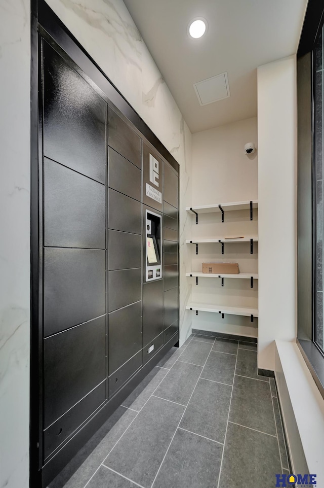 1125 Q St Unit 1401, Lincoln, NE 68508 - mudroom featuring dark tile patterned floors, recessed lighting, and elevator
