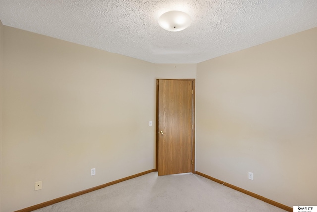 3909 N 147th St, Omaha, NE 68116 - unfurnished room featuring baseboards, light carpet, and a textured ceiling